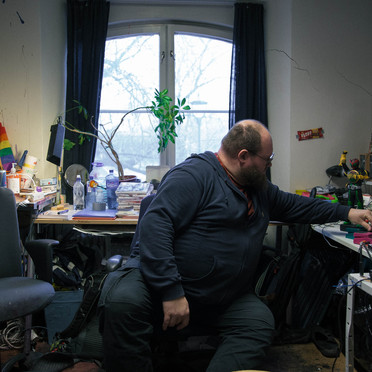 The artist seated at his desk.