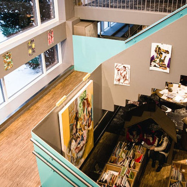 A staircase with paintings on the walls