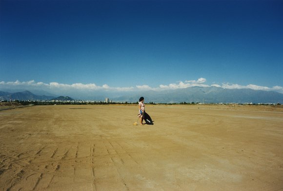 Worker collecting garbage in a landfill